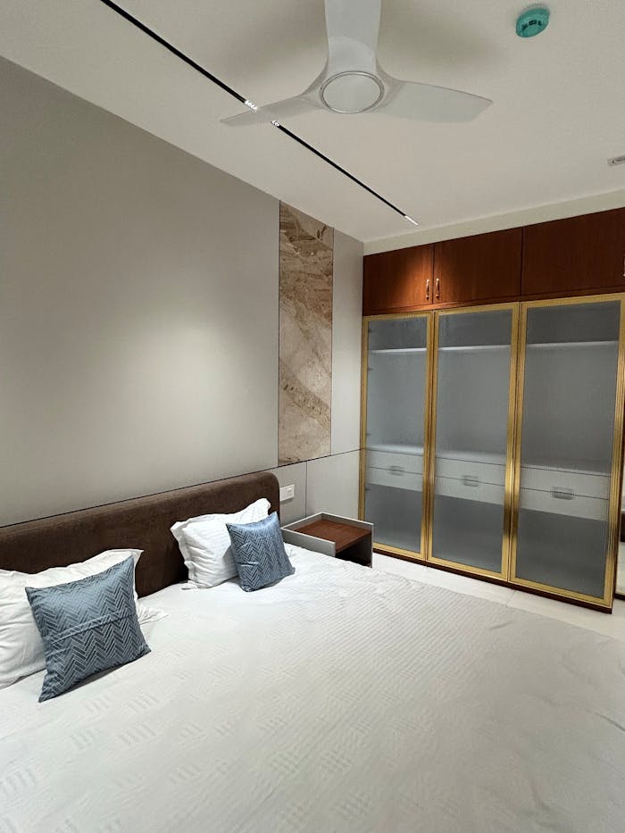 home-hero A minimalistic bedroom with neutral tones and elegant furnishings.